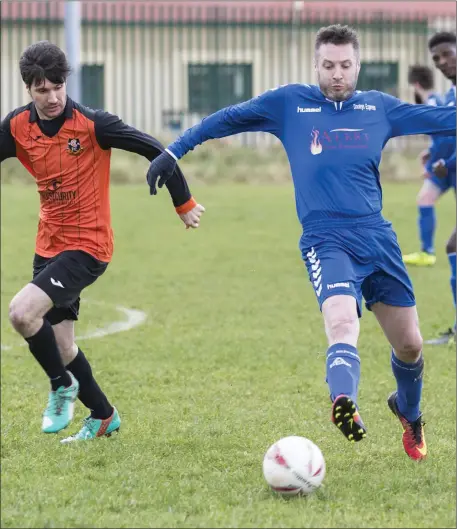  ??  ?? Paddy Rock of Corrib Rangers in action with Carbury’s Garreth Kelly in the Sean Fallon Park on Sunday. Pic: Donal Hackett.