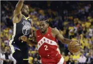  ?? BEN MARGOT — THE ASSOCIATED PRESS ?? In this June 13, 2019, file photo, Toronto Raptors forward Kawhi Leonard (2) drives against Golden State Warriors forward Andre Iguodala (9) during the first half of Game 6 of basketball’s NBA Finals in Oakland, Calif.