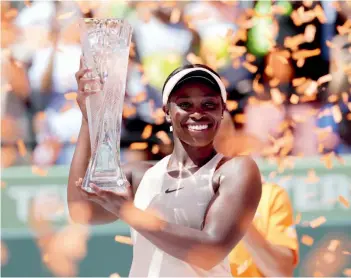  ?? AP ?? USA’s Sloane Stephens poses with the trophy after defeating Jelena Ostapenko of Latvia in the Miami Open final on Saturday at Key Biscayne. Stephens won 7- 6 ( 5), 6- 1. —