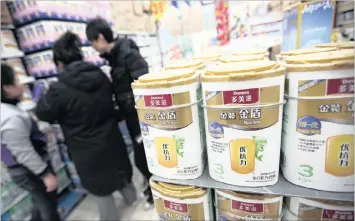  ??  ?? Customers shop for Danone brand Dumex instant baby formula at a store in Beijing, China. Danone, the world’s biggest yoghurt maker, says it has experience­d the slowest third-quarter sales growth in more than a decade.