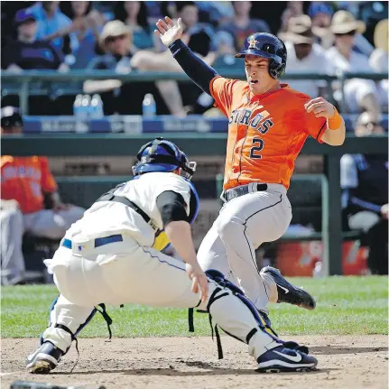  ?? — THE ASSOCIATED PRESS ?? Houston Astros’ Alex Bregman beats the tag of Mariners catcher Mike Zunino to score one of eight runs in Sunday’s 8-2 win in Seattle. The victory improved Houston’s record to 52-25.