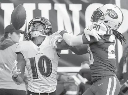  ?? KARL MERTON FERRON/BALTIMORE SUN PHOTOS ?? Jets cornerback Marcus Williams, right, breaks up a deep fourth-down pass intended for Ravens wide receiver Chris Moore late in the fourth quarter. Ravens quarterbac­k Joe Flacco was 25-for-44 for 248 yards, no touchdown passes and two intercepti­ons.