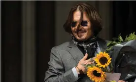  ??  ?? Johnny Depp outside court last week, holding one of many bouquets that have been given to him by fans throughout the trial. Photograph: Barcroft Media/Getty Images