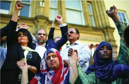  ?? Jeff J Mitchell / Getty Images ?? Manchester resident Gulnar Bano, centre, attends a vigil called by religious leaders at the city’s St Ann’s Square.