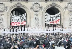  ??  ?? Paris Opera dancers perform in front of the Palais Garnier.