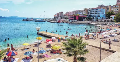  ?? PHOTOS: GETTY IMAGES ?? On the cusp of change . . . Saranda beach is a popular spot during summer.