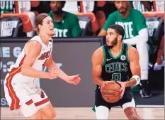  ?? Mike Ehrmann / Getty Images ?? The Celtics’ Jayson Tatum is defended by the Heat’s Kelly Olynyk during Game 5 of the Eastern Conference Finals on Friday in Lake Buena Vista, Fla.