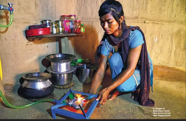  ??  ?? A villager in Bharatpur cooks up a storm on her new biogas stove