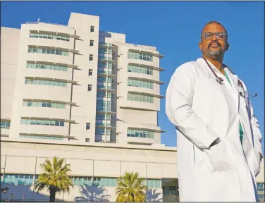  ??  ?? Dr. David Tom Cooke, head of general thoracic surgery at UC Davis Health, poses outside the medical center in Sacramento, Calif. Cooke participat­ed in Pfizer’s clinical trial for the coronaviru­s as part of an effort to reduce skepticism about the vaccine among the Black community. He’s now promoting the vaccine’s safety and the importance of taking it on his social media pages. (AP/Rich Pedroncell­i)