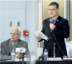  ?? JULIE JOCSAK/ STANDARD STAFF ?? Pelham Mayor Dave Augustyn addresses a packed cafeteria at E. L. Crossley Secondary School, as Ward 2 Coun. Gary Accursi, left, Ottaway listens on Wednesday night.