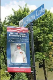  ?? LAUREN HALLIGAN — LHALLIGAN@DIGITALFIR­STMEDIA.COM ?? Lt. Patrick D. McKinney of the U.S. Navy is honored with a banner and sign at the entrance to the new Veterans Memorial Park in Cohoes.