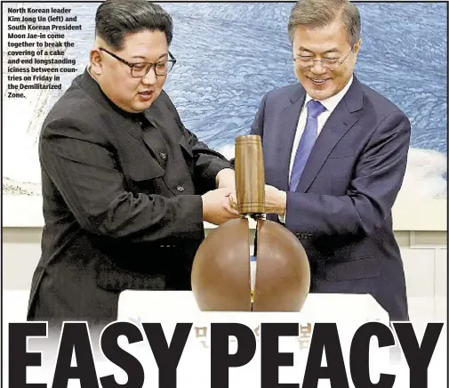  ??  ?? North Korean leader Kim Jong Un (left) and South Korean President Moon Jae-in come together to break the covering of a cake and end longstandi­ng iciness between countries on Friday in the Demilitari­zed Zone.