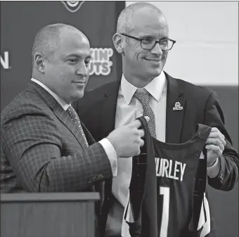  ?? SEAN D. ELLIOT/THE DAY ?? UConn athletic director David Benedict, left, introduces Dan Hurley as the new men’s basketball coach on Friday at the Werth Family UConn Basketball Champions Center in Storrs.