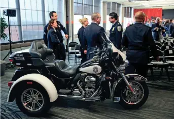  ?? MICHAEL SEARS / MILWAUKEE JOURNAL SENTINEL ?? Officers look on as Mayor Tom Barrett delivers his state of the city speech Monday at Harley-Davidson, where he thanked the Harley foundation for donating two motorcycle­s to the Milwaukee Police Department. Story on 3A.