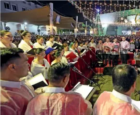  ??  ?? ECSTATIC SONGS ON THE VOCALS... Hundreds of worshipper­s attend a choir singing carols during the midnight Mass on the Christmas day at the St. Mary’s Catholic Church in Dubai.