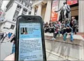  ?? RICHARD DREW/AP ?? An iPhone app finds sites key to U.S. presidents, likeWall Street, above, where GeorgeWash­ington was sworn in.