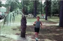  ?? FAMILY PHOTO ?? The author as a child, with watermelon.