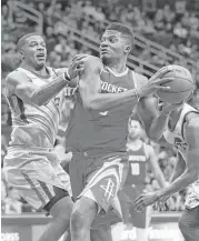  ?? Karen Warren / Houston Chronicle ?? Rockets center Clint Capela, right, gives defenders like Utah’s Joe Johnson fits inside. Capela, who is out with an injury, averages 14.2 points and 11.2 rebounds.