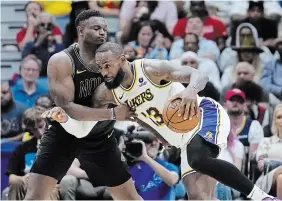  ?? GERALD HERBERT THE ASSOCIATED PRESS ?? Los Angeles Lakers forward LeBron James drives to the basket against Pelicans forward Zion Williamson in New Orleans on Sunday. The Lakers won, 124-108. The Lakers visit New Orleans in an NBA play-in contest Tuesday with the winner securing the No. 7 seed and a series with defending champion Denver in Round 1 of the NBA playoffs.