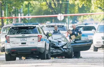  ?? Jose M. Osorio Chicago Tribune ?? CHICAGO POLICE at the site of an officer-involved shooting. Officers last week killed an 18-year-old man, Paul O’Neal, who officials say was driving a stolen Jaguar and sideswiped a squad car before the incident.