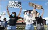  ?? BEA AHBECK/NEWS-SENTINEL ?? Andrea Ramos and sisters Danielle and Ashley Welch, all of Lodi, participat­e in a protest for human rights at the corner of Kettleman Lane and Lower Sacramento Road in Lodi on Saturday.