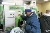  ?? LUTHER TURMELLE — NEW HAVEN REGISTER ?? Abraham Robinson of Meriden recycles bottles Tuesday at the M&amp;M Redemption Center in Wallingfor­d.