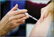  ?? MATT ROURKE — THE ASSOCIATED PRESS FILE ?? A health worker administer­s a dose of a COVID-19vaccine during a vaccinatio­n clinic Dec. 15at the Keystone First Wellness Center in Chester, Pa.