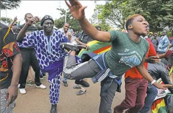  ?? Tsvangiray­i Mukwazhi/Associated Press ?? Euphoric crowds march and dance in Harare, Zimbabwe, on Saturday, demanding the departure of President Robert Mugabe. The military, which put Mr. Mugabe under house arrest, approved the demonstrat­ion that included people from across the political...