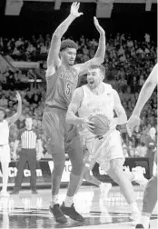  ?? ROBERT FRANKLIN/AP ?? Notre Dame’s John Mooney drives by Louisville’s Malik Williams (5) during a Saturday, Jan. 11, game in South Bend, Indiana. Louisville won 67-64. Mooney, a former Lake Brantley standout, leads NCAA Division I players in doubledoub­les for the 2019-20 season.