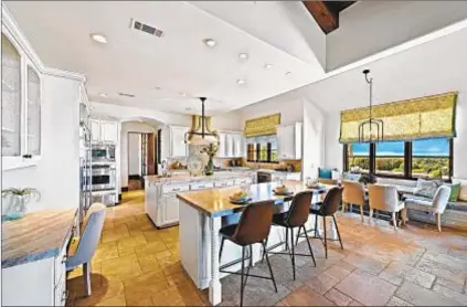  ?? Bowman Media Group ?? TWO ISLANDS are paired with a breakfast nook in the chef ’s kitchen of Philip Rivers’ home.