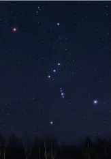  ??  ?? Betelgeuse glows red on Orion’s shoulder while the pink nebula hangs in a line below his belt