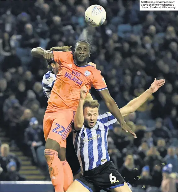  ??  ?? Sol Bamba, rising imperiousl­y above Sheffield Wednesday’s Jordan Rhodes at Hillsborou­gh