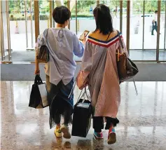  ??  ?? At a shopping centre at the Lujiazui Financial District in Pudong in Shanghai. The hit TV show ‘Ode to Joy’ centres around five young women from different background­s in Shanghai. — AFP photo