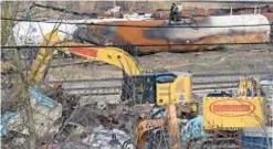 ?? AP ?? Workers continue to clean up remaining tank cars Tuesday after Feb. 3 derailment and chemical release.