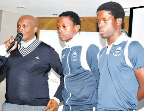  ??  ?? Richards Bay FC Chairman Jomo Biyela with local youngsters Moses Mthembu and Sabelo Mkhwanazi. Both new signings are still at school and they are being given a shot at the world of profession­al football that could change their lives, as well as those of their families Dave Savides