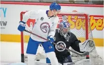  ?? AP PHOTO/DAVID ZALUBOWSKI ?? Colorado Avalanche center Nico Sturm redirects a shot on the net as he takes part in Tuesday’s practice before Game 1 of the Stanley Cup Finals against the Tampa Bay Lightning.