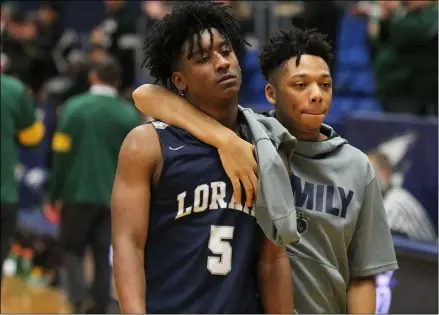  ?? RANDY MEYERS — FOR THE MORNING JOURNAL ?? A dejected Deonte Benejan of Lorain walks off the court with a teammate after losing to St. Edward on March 11