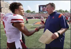  ?? (AP/Charles Rex Arbogast) ?? Illinois Coach Bret Bielema shakes hands with Nebraska quarterbac­k Adrian Martinez after the Fighting Illini’s 30-22 victory over the Cornhusker­s on Saturday in Champaign, Ill.