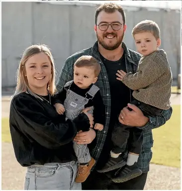  ?? JOHN KIRKANDERS­ON/STUFF ?? Alex Hannah, holding Rhodes, 3, with wife Carissa and Darby, 1. Alex now has weekends free for the family, church and community.