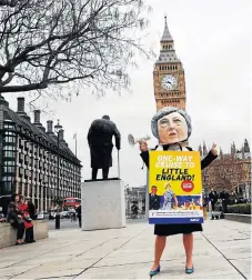  ?? /Reuters ?? Big move: An anti-Brexit protester with a giant Theresa May head wears a sandwich board outside parliament, in London.