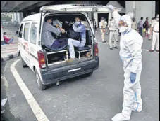  ?? ANI ?? Migrant workers with Covid-19 symptoms being taken for testing, at Anand Vihar Bus Terminal. Over 30 million samples have been tested for Covid so far, the health ministry said on Monday. >>P4