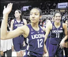  ??  ?? Connecticu­t guard Saniya Chong and her teammates wave to fans after beating SMU 88-48 on Saturday for a record-setting 91st straight victory.