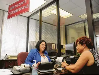  ?? Dave Rossman photos ?? Branch manager Malena Vega helps Cheryl Nelson with a new account at Unity National Bank. During the 2008 recession, the bank was able to avoid taking any government bailouts.