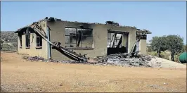  ??  ?? MOB JUSTICE: The burnt-out shell of a house belonging to a man the residents believe abducted son of ex-Robben Island prisoner