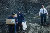  ?? Bobby Block/The Signal ?? Detectives from the Los Angeles County Sheriff’s Department Homicide Bureau collect a set of human remains Saturday reported in a burned area alongside Sand Canyon Road for investigat­ion.