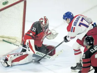  ?? GEOFF ROBINS/THE CANADIAN PRESS ?? The Czech Republic’s Krystof Hrabik tries to put the puck past Canada’s goalie Carter Hart during the third period of their World Junior Ice Hockey Championsh­ips pre-tournament game, in London Ont., on Wednesday.