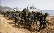 ?? LEE JIN-MAN / ASSOCIATED PRESS 2015 ?? South Korean Marines march after landing on the beach during the U.S.-South Korea joint landing military exercises as a part of the annual joint military exercise Foal Eagle between South Korea and the United States in Pohang, South Korea.