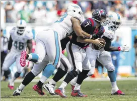  ?? JOEL AUERBACH / ASSOCIATED PRESS ?? Dolphins defensive tackle Ndamukong Suh gets to the Texans’ Brian Hoyer, one of four times Hoyer was sacked on Sunday.