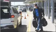  ?? (NWA Democrat-Gazette/Charlie Kaijo) ?? Randy Fox of Fayettevil­le loads his luggage into a car Friday at Northwest Arkansas National Airport in Highfill. Andrew Branch, chief developmen­t officer for the airport, said a new taxiway is on hold awaiting infrastruc­ture money. Go to nwaonline.com/210405Dail­y/ for today’s photo gallery.