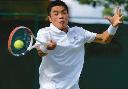  ?? ALASTAIR GRANT/AP ?? Brandon Nakashima, a former University of Virginia player, drives a forehand Thursday during his four-set victory over No. 13 seed Denis Shapovalov in Wimbledon’s second round.
